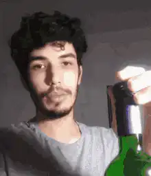 Man chugging a green bottle