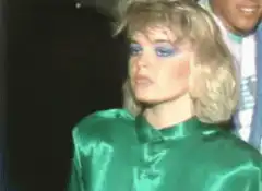 Kim Gordon in green satin shirt