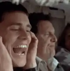 Man screaming with hands on ears