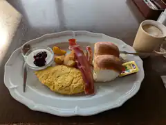 breakfast plate with omelet bacon and coffee