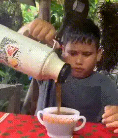 Boy pours and drinks coffee