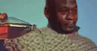 man pouring liquid on shoulder