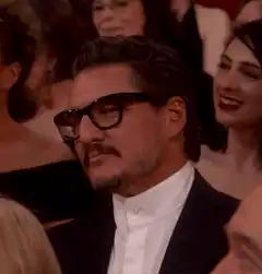 Pedro Pascal adjusting his glasses
