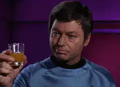 Majel Barrett as Nurse Chapel holding a drink