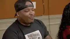 Man in Black Panther shirt nodding