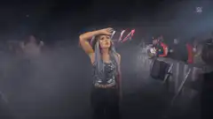 Giulia walks through smoke at WWE event