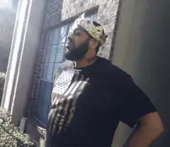 Man in crown looking up then smiling