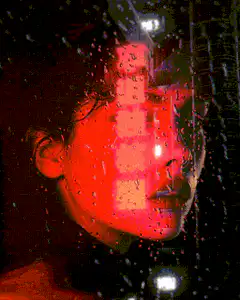 Woman's face behind rain-streaked glass with red neon light