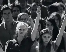Crowd raising hands in black and white