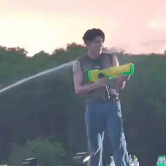 Man shooting water gun on stage