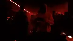 person in red hoodie dancing in club