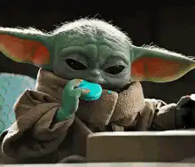 Baby Yoda eating a blue cookie