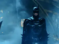 Batman standing in smoke