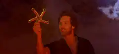 Wolverine holds up the X-Men logo