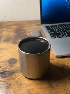 steaming metal cup on desk