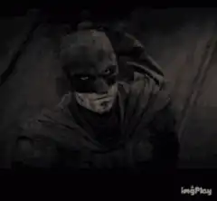 Batman looking around in the dark