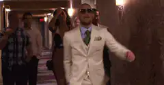 Burt Reynolds walks down a hallway
