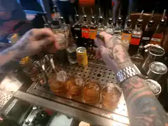 Bartender stirring four drinks
