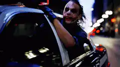 Joker laughing in police car