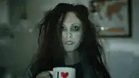 Zombie woman drinks coffee and transforms