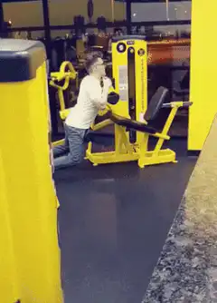 Woman doing kneeling chest press at gym