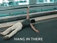 Man hanging from moving walkway
