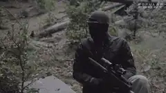 Masked man with rifle in woods