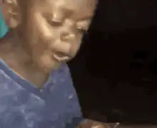 Boy eating sandwich and smiling