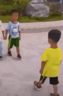 Boy in yellow shirt bows and falls