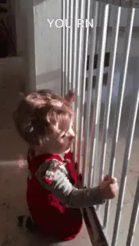 Toddler shaking metal bars