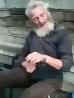 Old man with white beard dancing