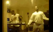 Two men dancing in a room