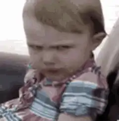 Toddler eating with intense stare