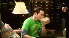 Sheldon eats a sandwich