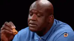 Shaquille O'Neal eating a chicken nugget