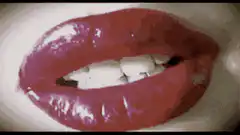 Glossy red lips licking teeth