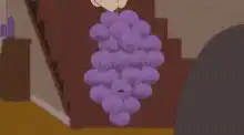 Mr. Mackey holding a bunch of purple grapes