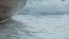 Captain Jack Sparrow walks off a boat on a beach