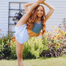 Girl doing standing split in garden