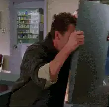 man hiding behind a board