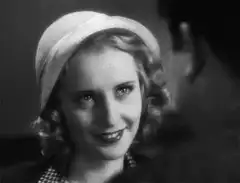 Woman in hat smiling flirtatiously