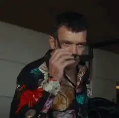 Man puts on sunglasses