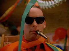 man with party blower and sunglasses