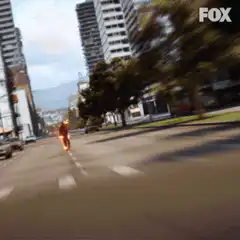 The Flash running down a city street