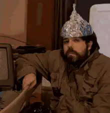 Man in tinfoil hat gives thumbs up