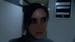 Jennifer Connelly looking down in hallway
