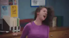 Girl screaming in purple shirt