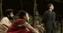 Man flips coin in jungle