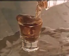pouring whiskey into shot glass