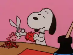 Snoopy cuts paper heart for Sally